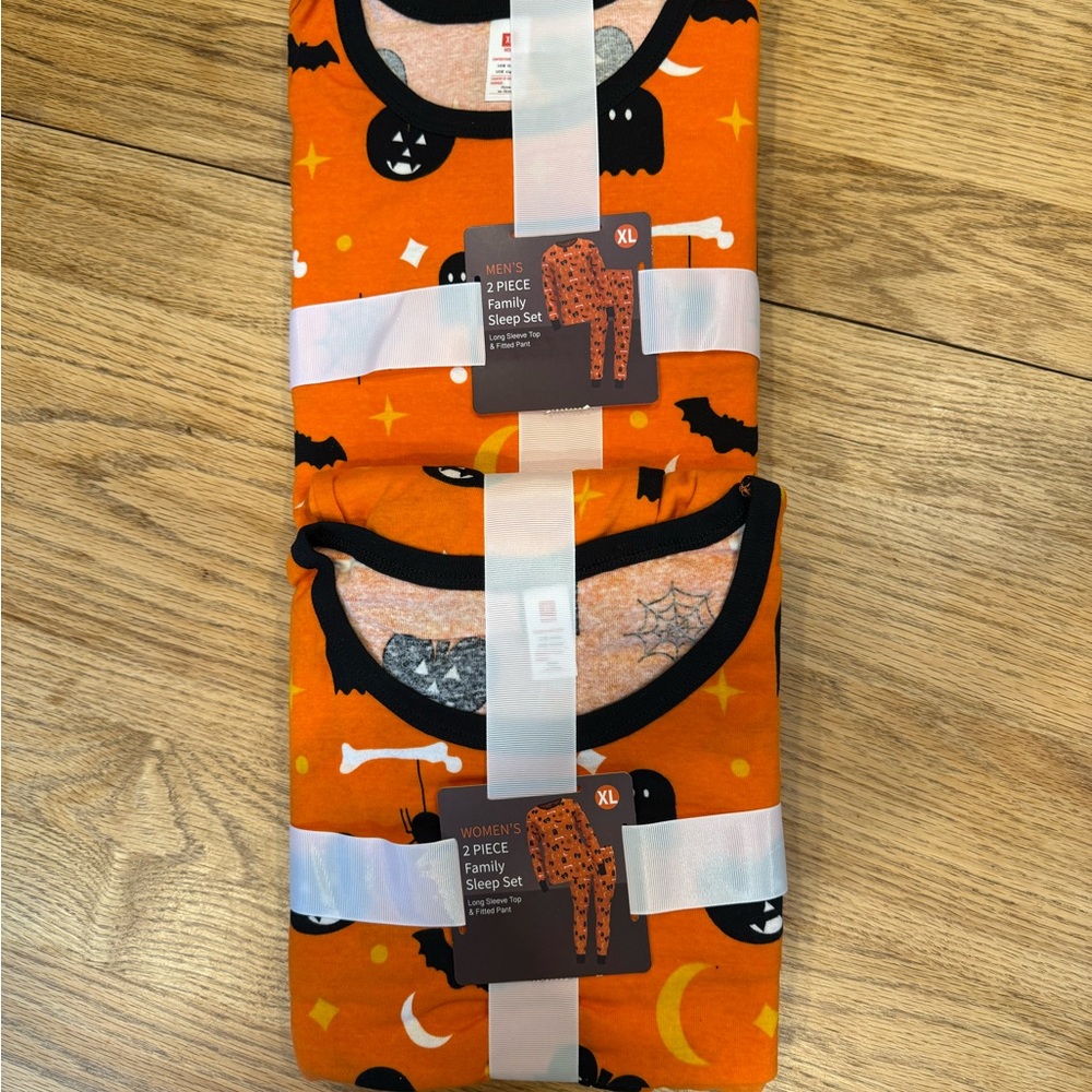 Two pairs of  Halloween Pajama Sets with Spooky Prints. Women XL and Men XL.